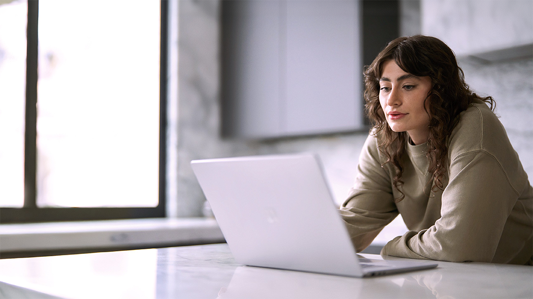 Woman sitting at a table using a laptop